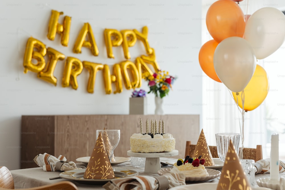 a birthday party with a cake and balloons