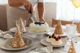 a person cutting a cake with a knife