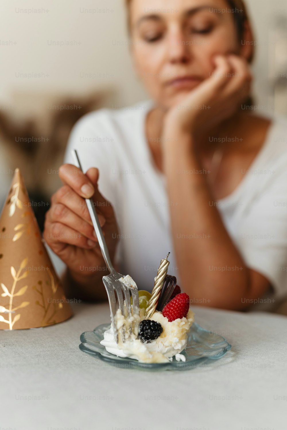 a woman sitting at a table with a plate of food