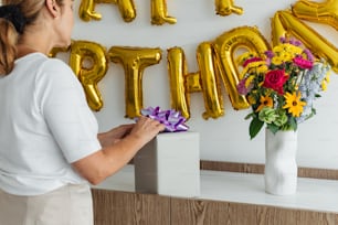 a woman placing a bouquet of flowers in a vase