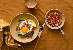 a table topped with two bowls filled with food