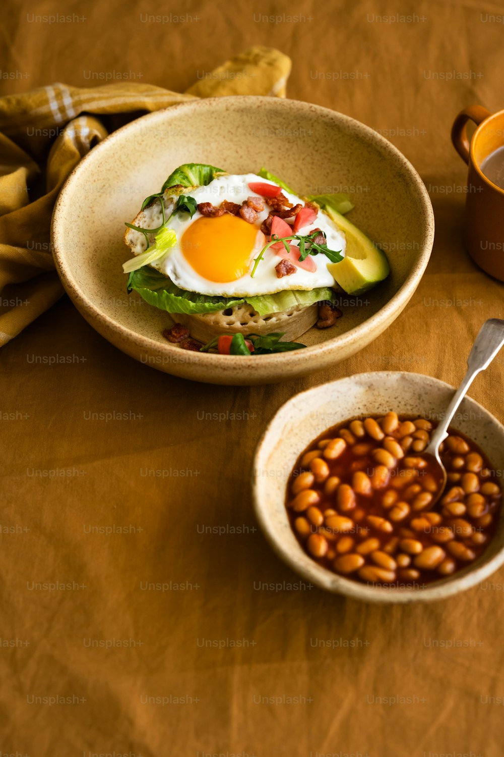 a bowl of beans and a bowl of eggs on a table