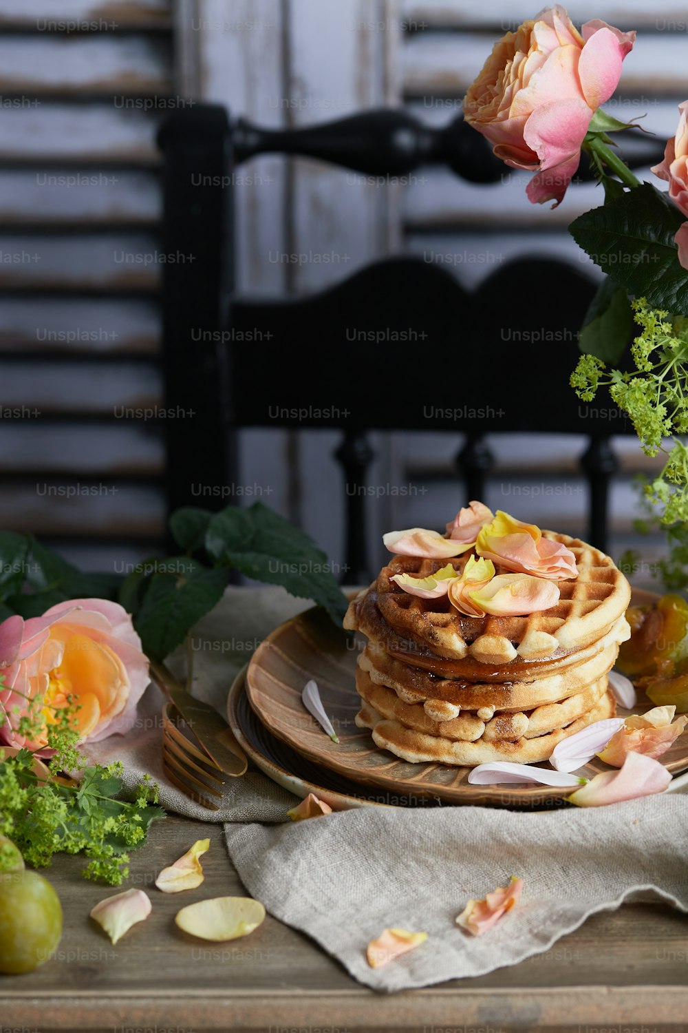 a stack of pancakes sitting on top of a wooden plate