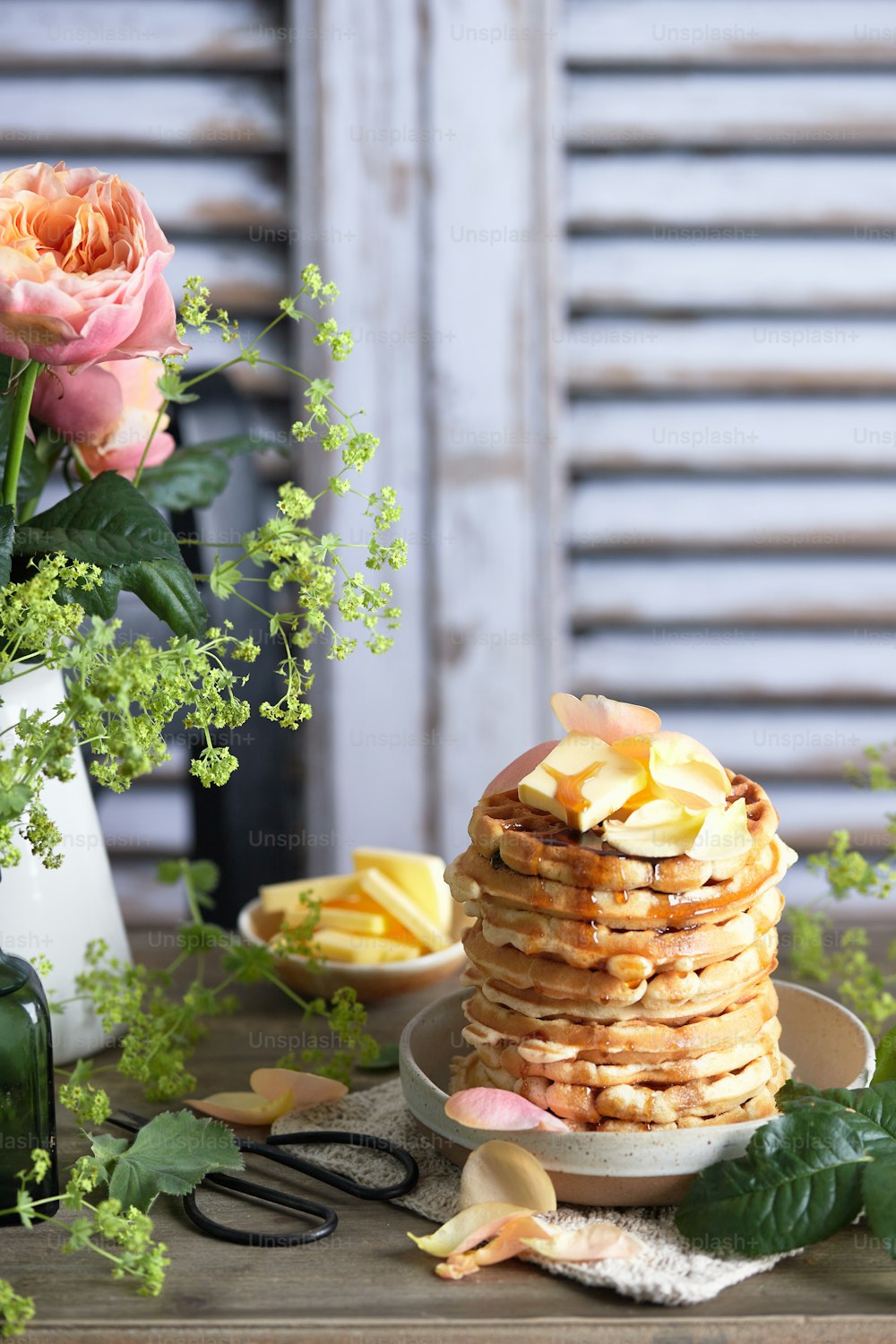 a stack of pancakes sitting on top of a wooden table
