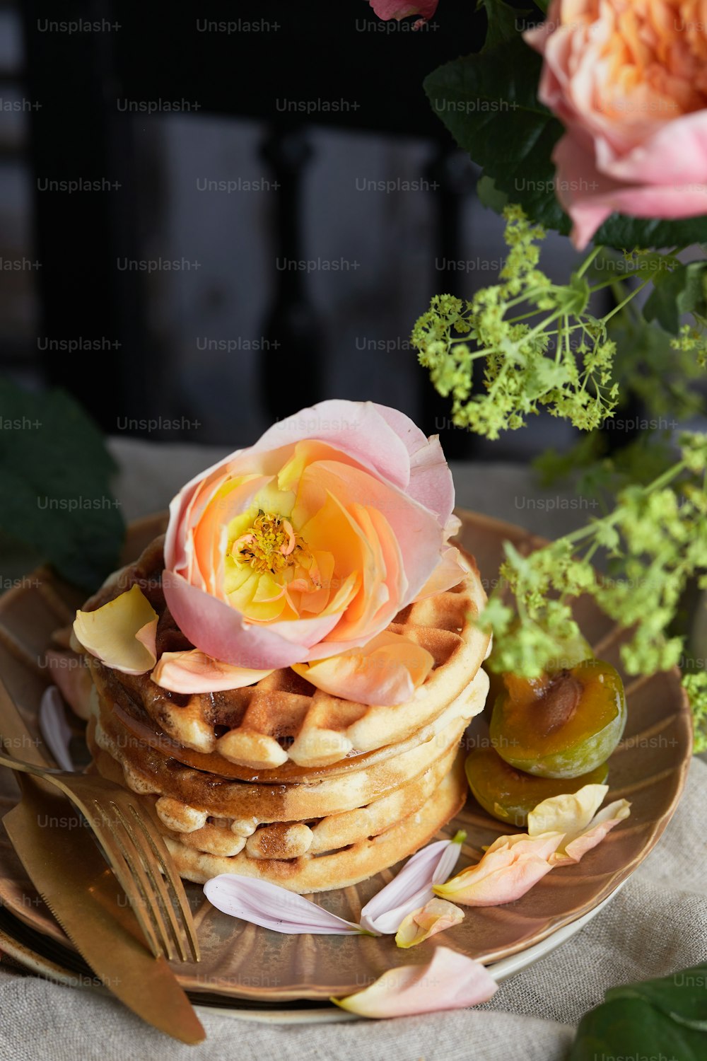 a stack of waffles with a flower on top