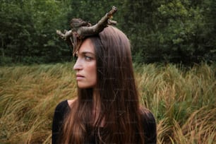 a woman with long hair wearing a horned crown