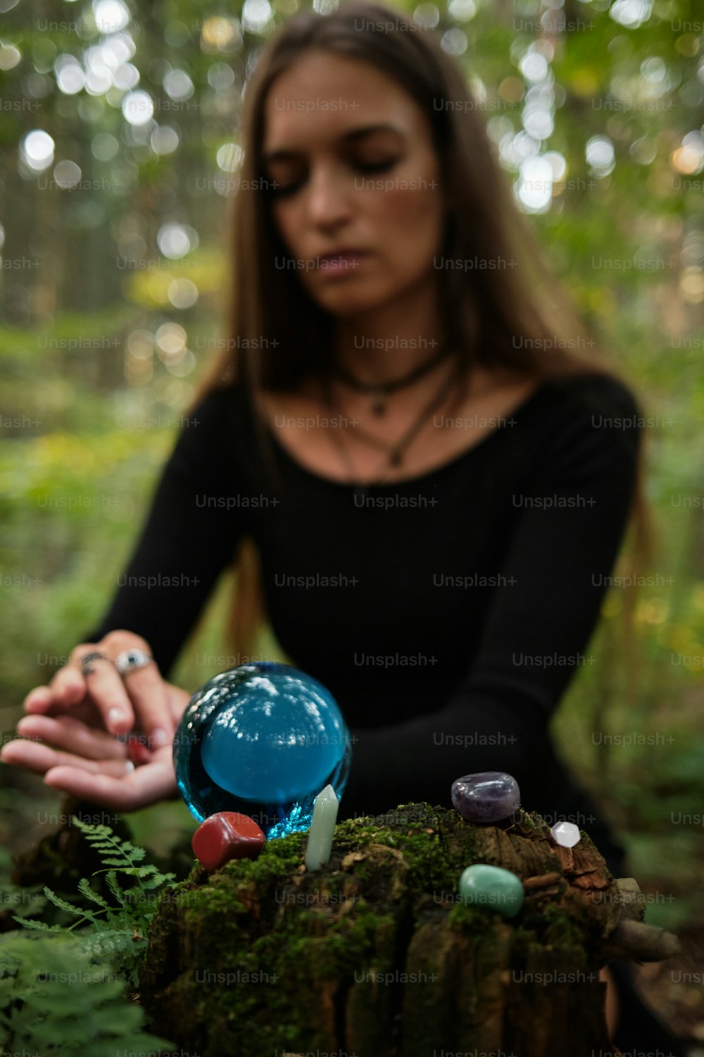 a woman in a black shirt is holding a blue ball