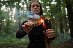 a woman holding a lit match in her hands