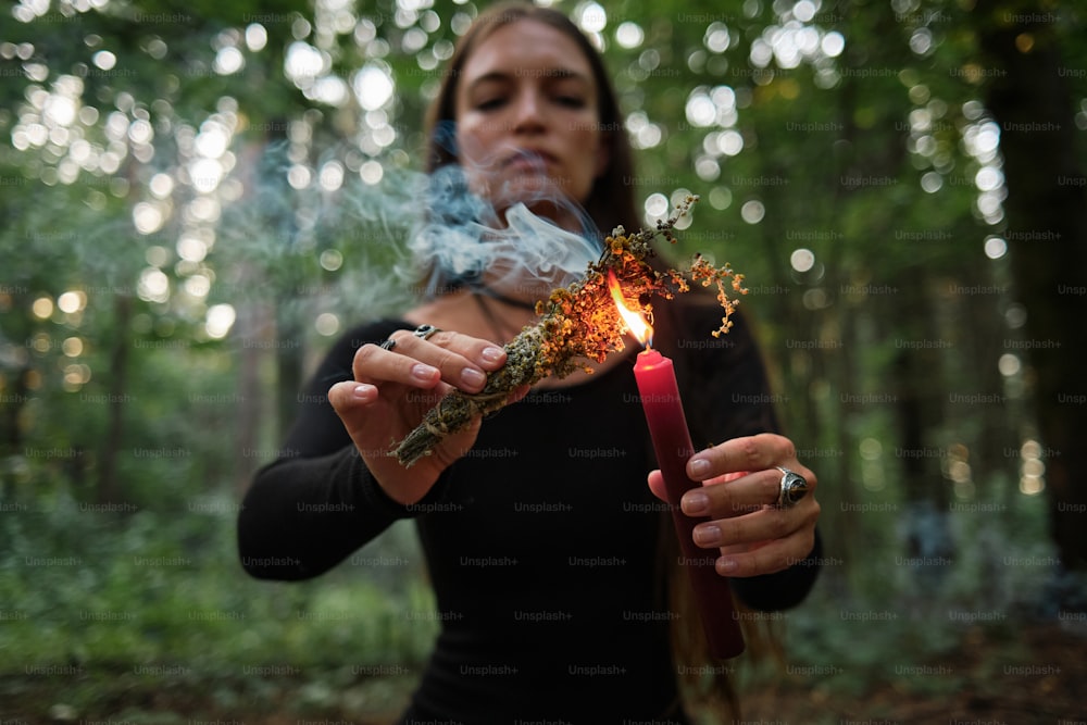a woman holding a lit match in her hands