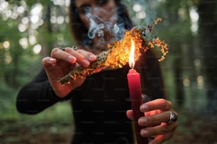 a woman holding a lit candle in her hands