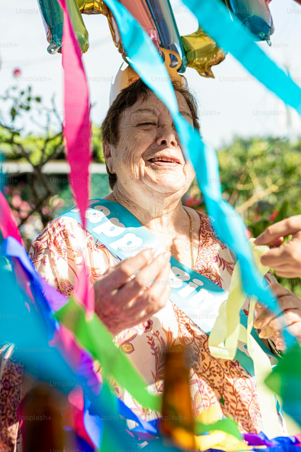 a woman holding a bunch of colorful streamers