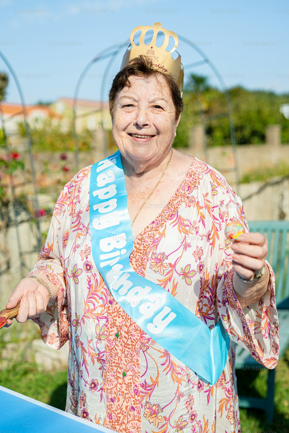a woman wearing a tiara and holding a piece of cake