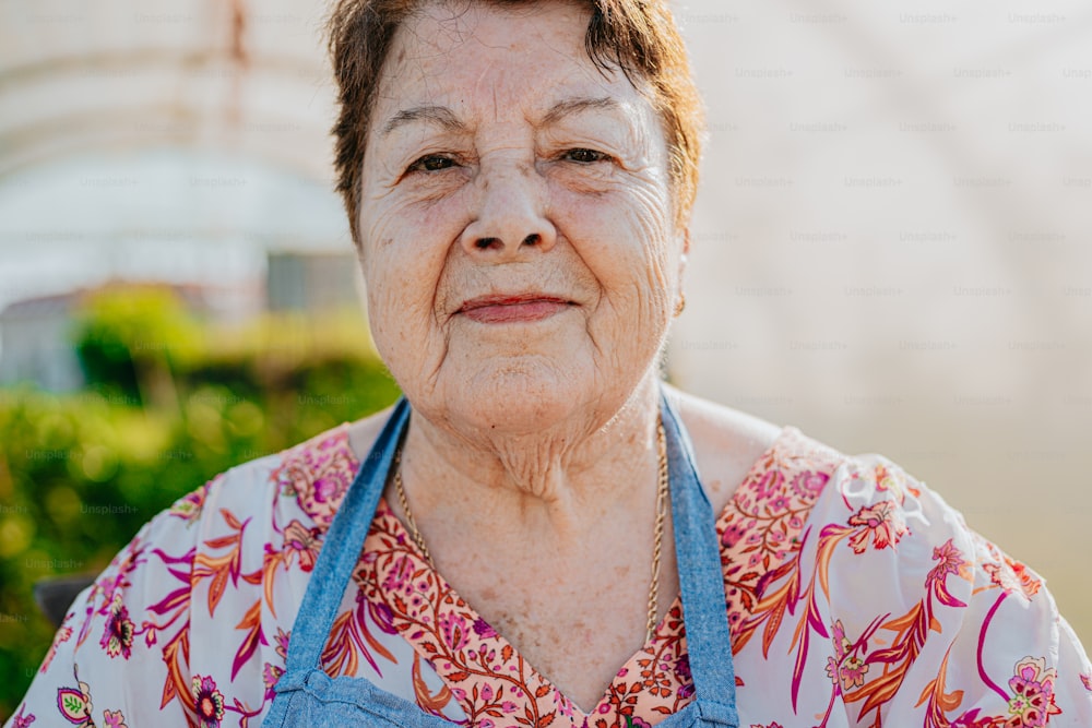 an older woman with a blue apron on