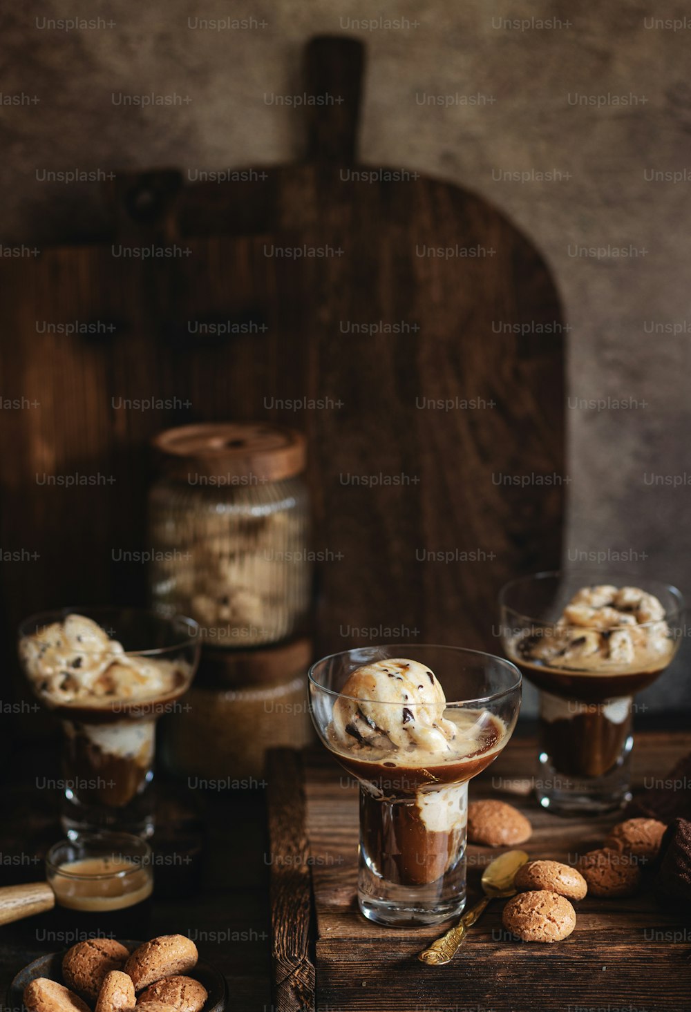 a wooden table topped with desserts and nuts