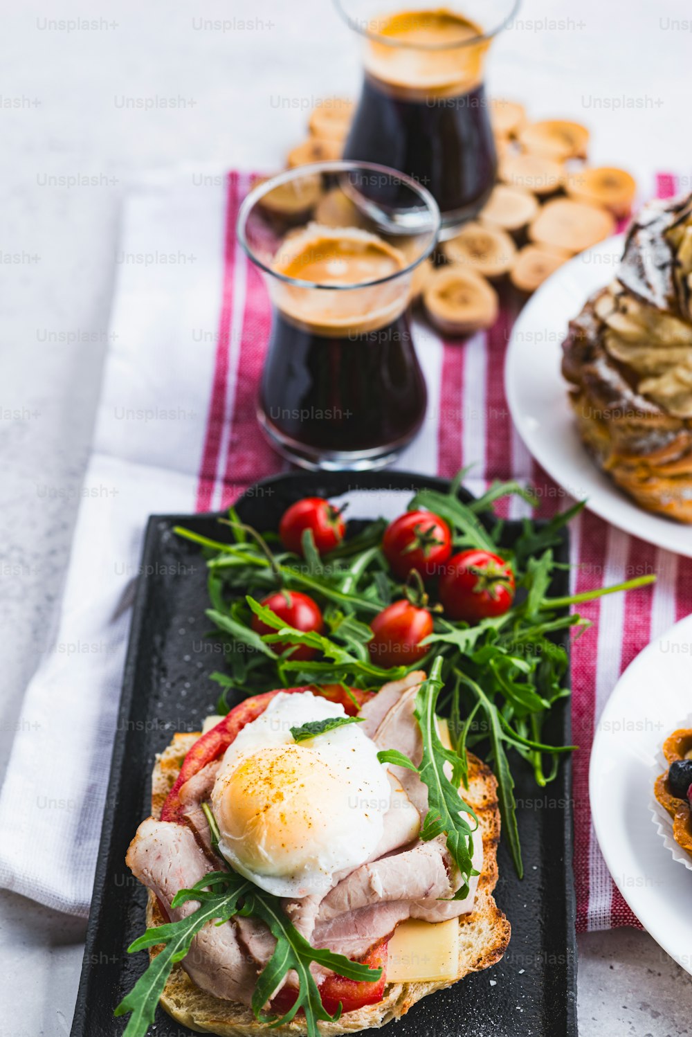 a table topped with plates of food and drinks