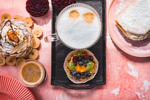 a table topped with plates of food and desserts