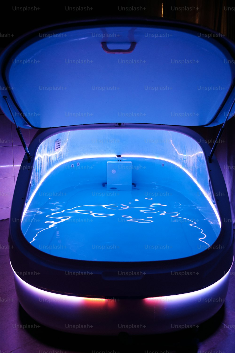 a large pool with a blue light inside of it