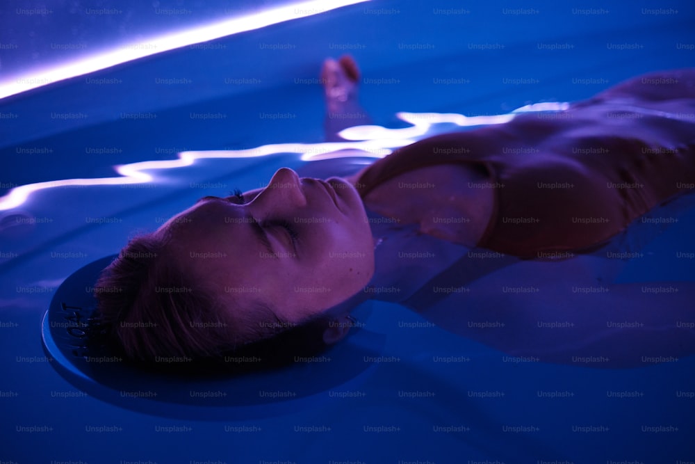 a woman laying down in a pool of water
