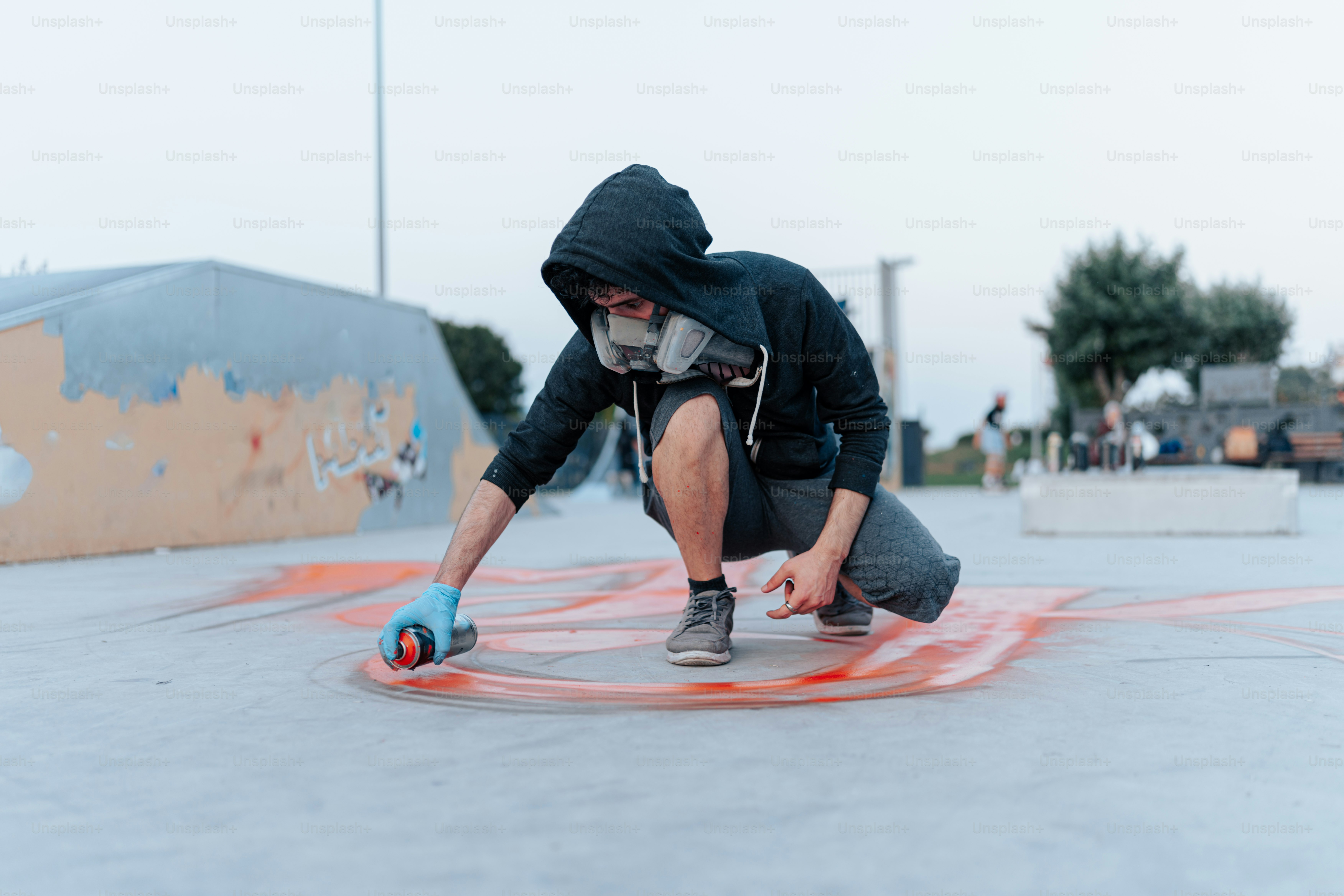 a man kneeling down on a skateboard in a skate park