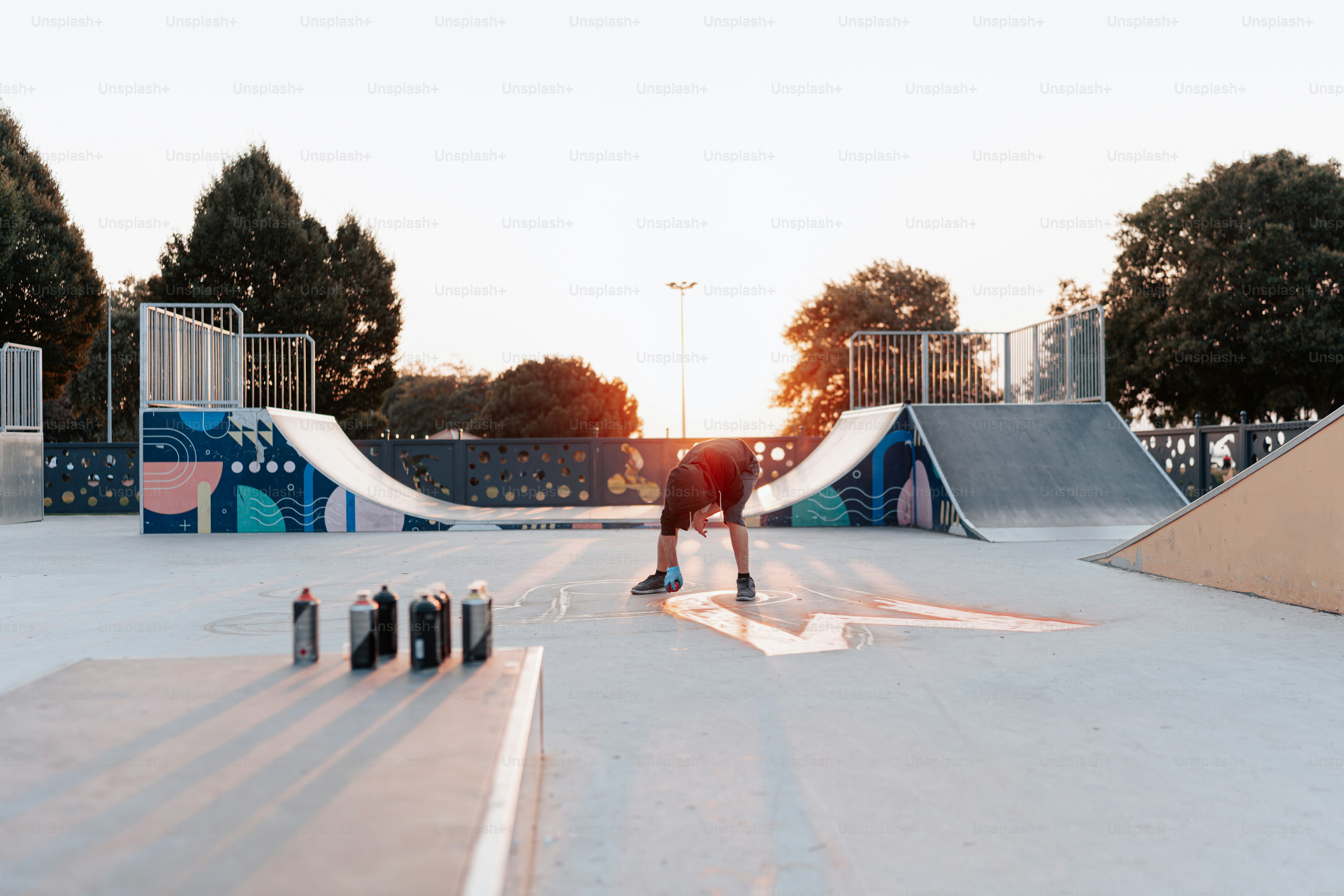 A man riding a skateboard on top of a ramp photo – Graffiti Image on ...