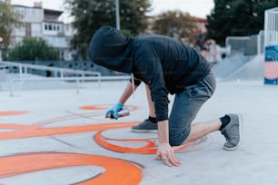 a man in a black hoodie is doing a trick on a skateboard