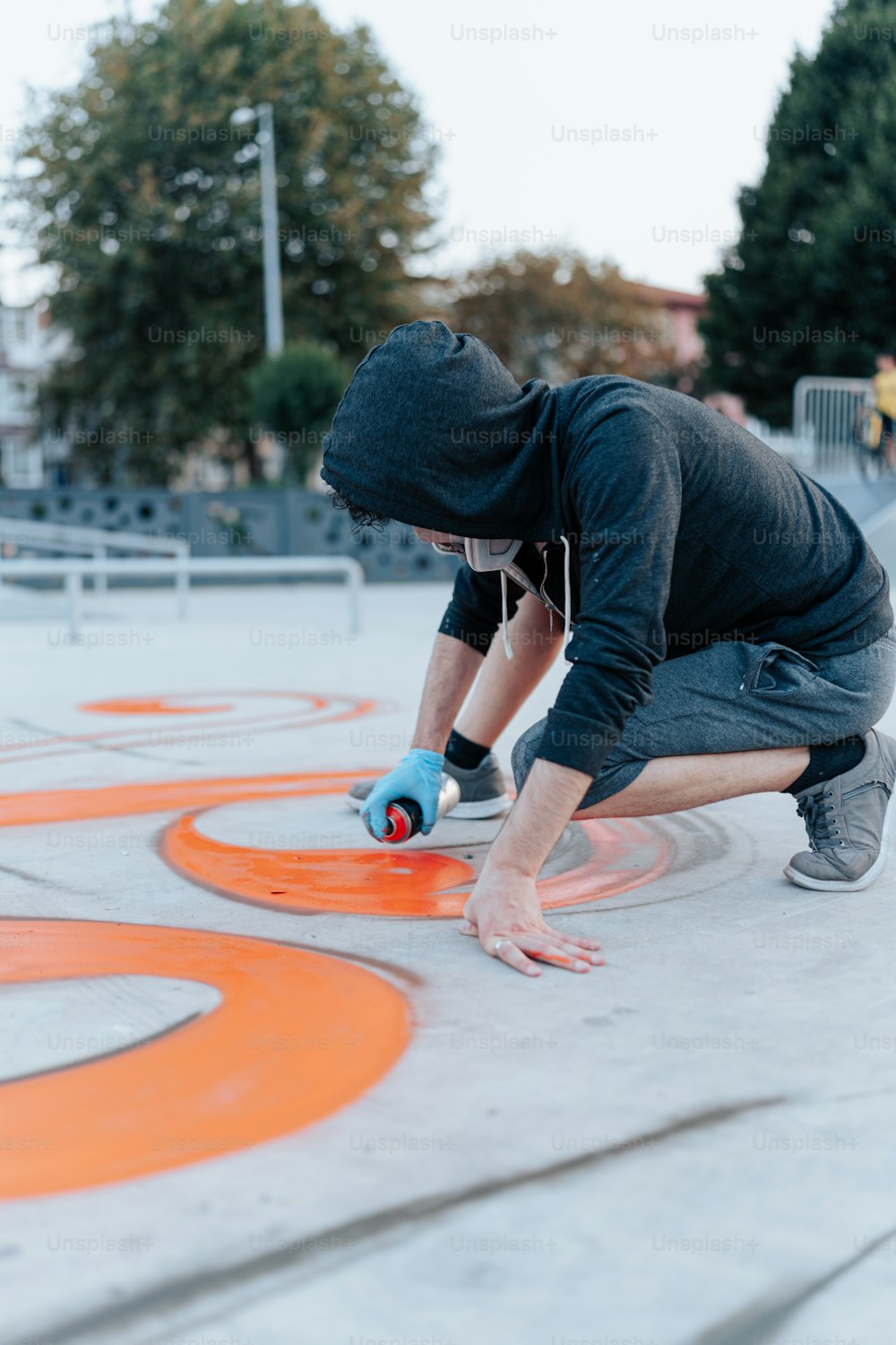 a man kneeling down on a skateboard in a skate park