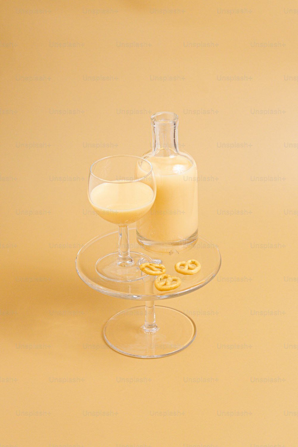 a glass of milk and a bottle of milk on a yellow background