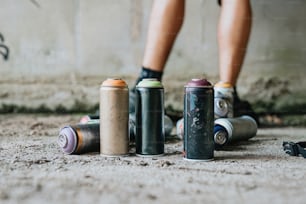 a person standing next to a group of cans