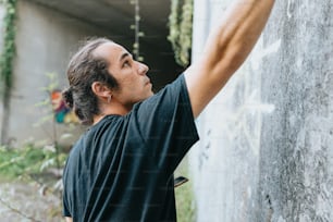 a man writing on the side of a wall