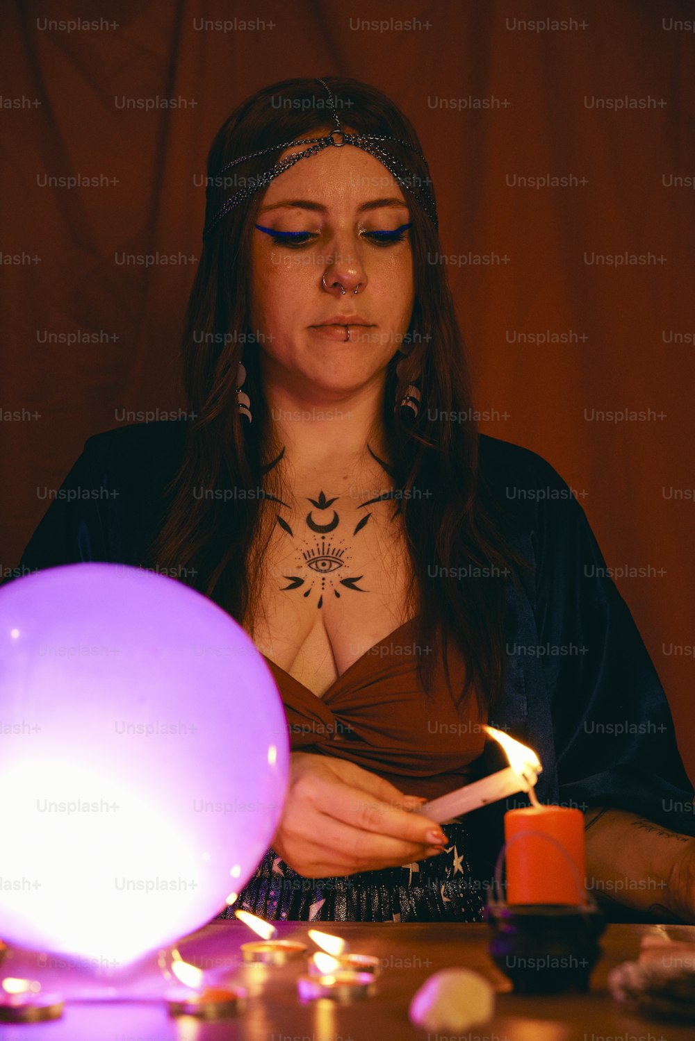 a woman holding a lit candle in her hands