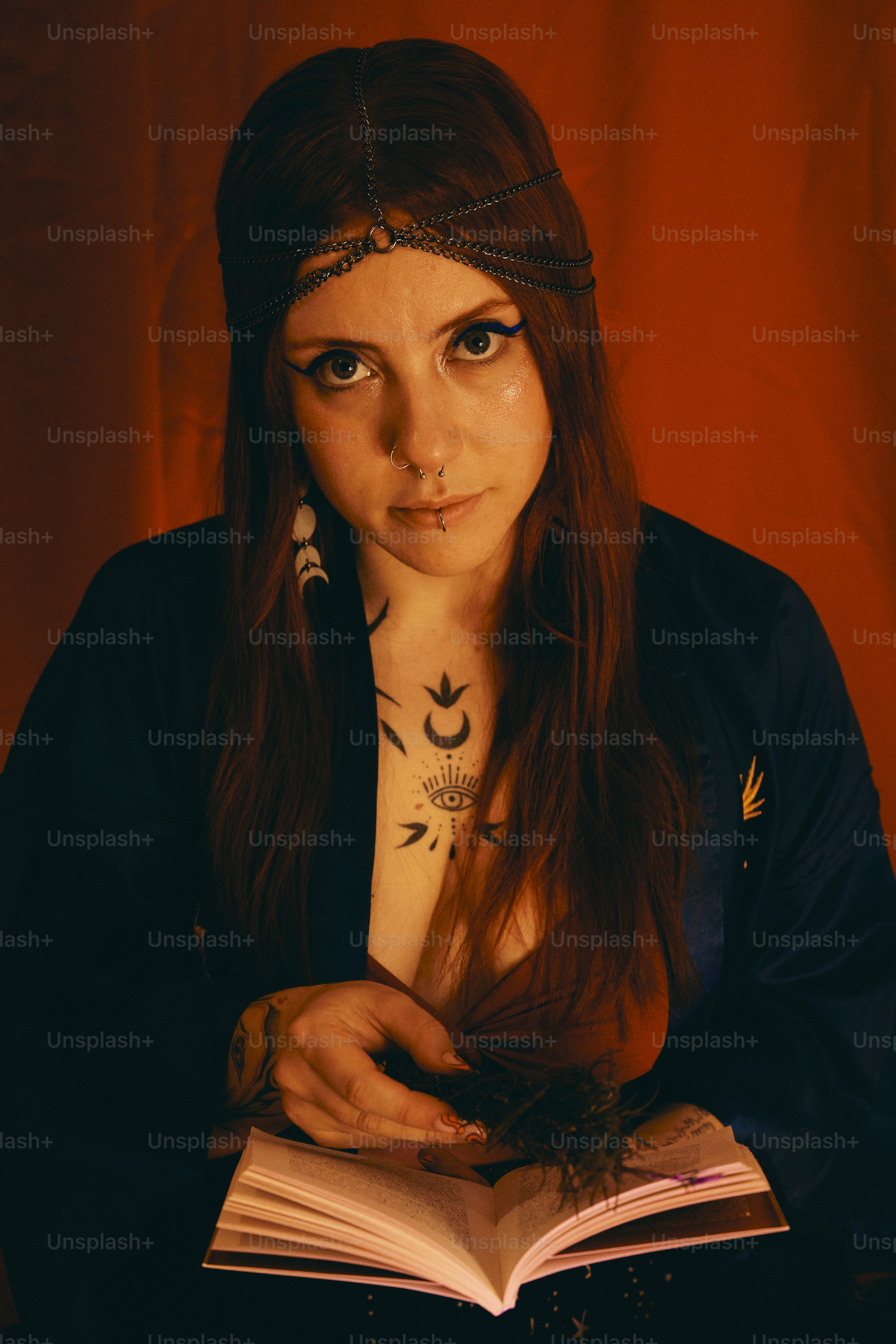 a woman with tattoos is reading a book