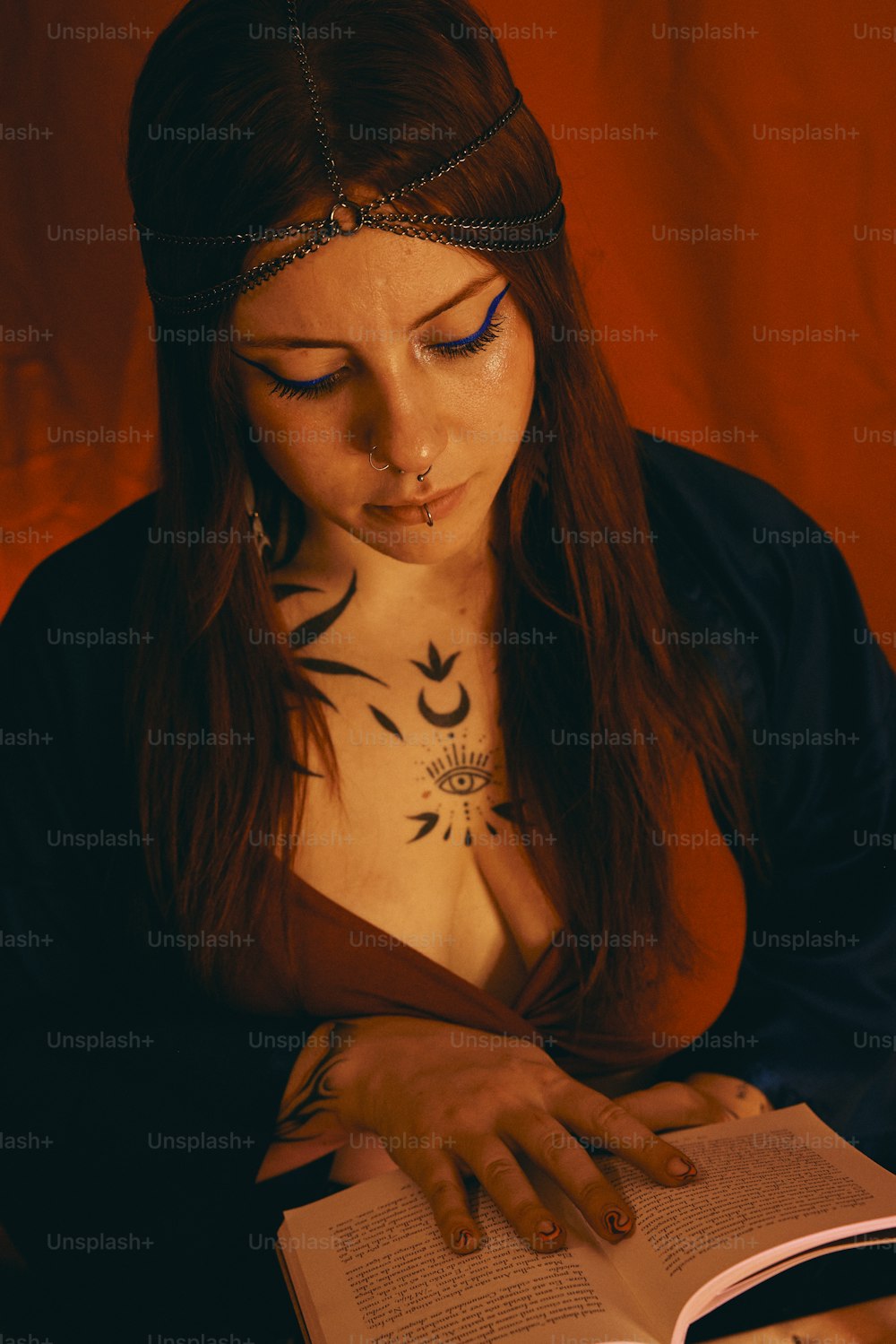 a woman with tattoos reading a book