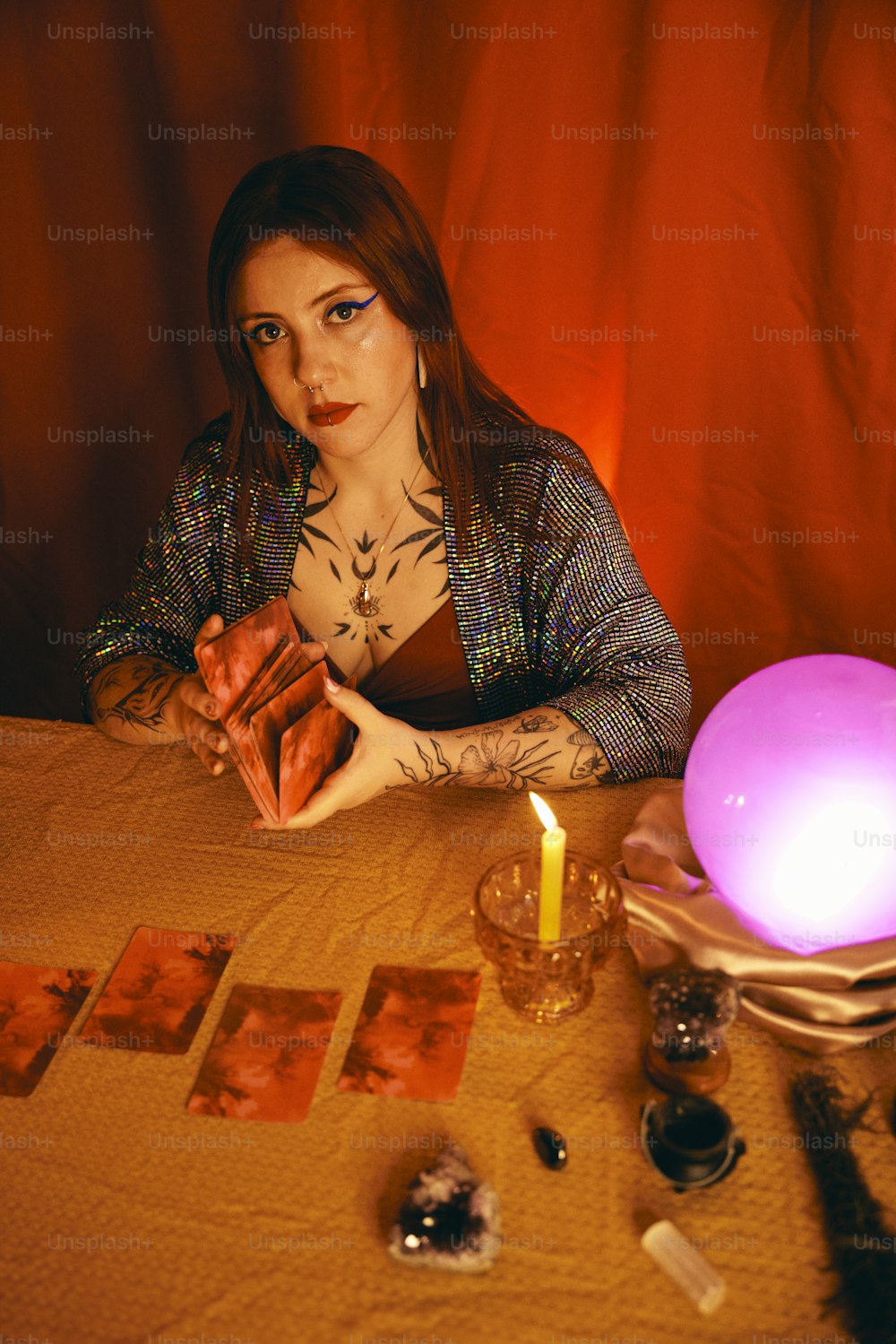 a woman sitting at a table with a lit candle