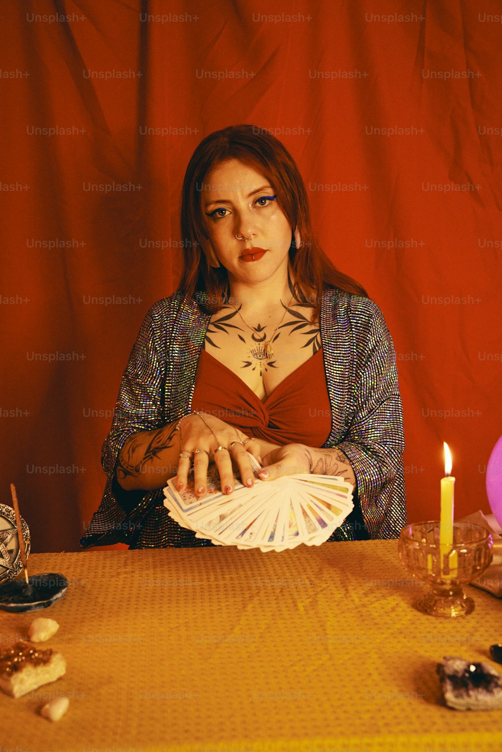 a woman sitting at a table with a lot of cards