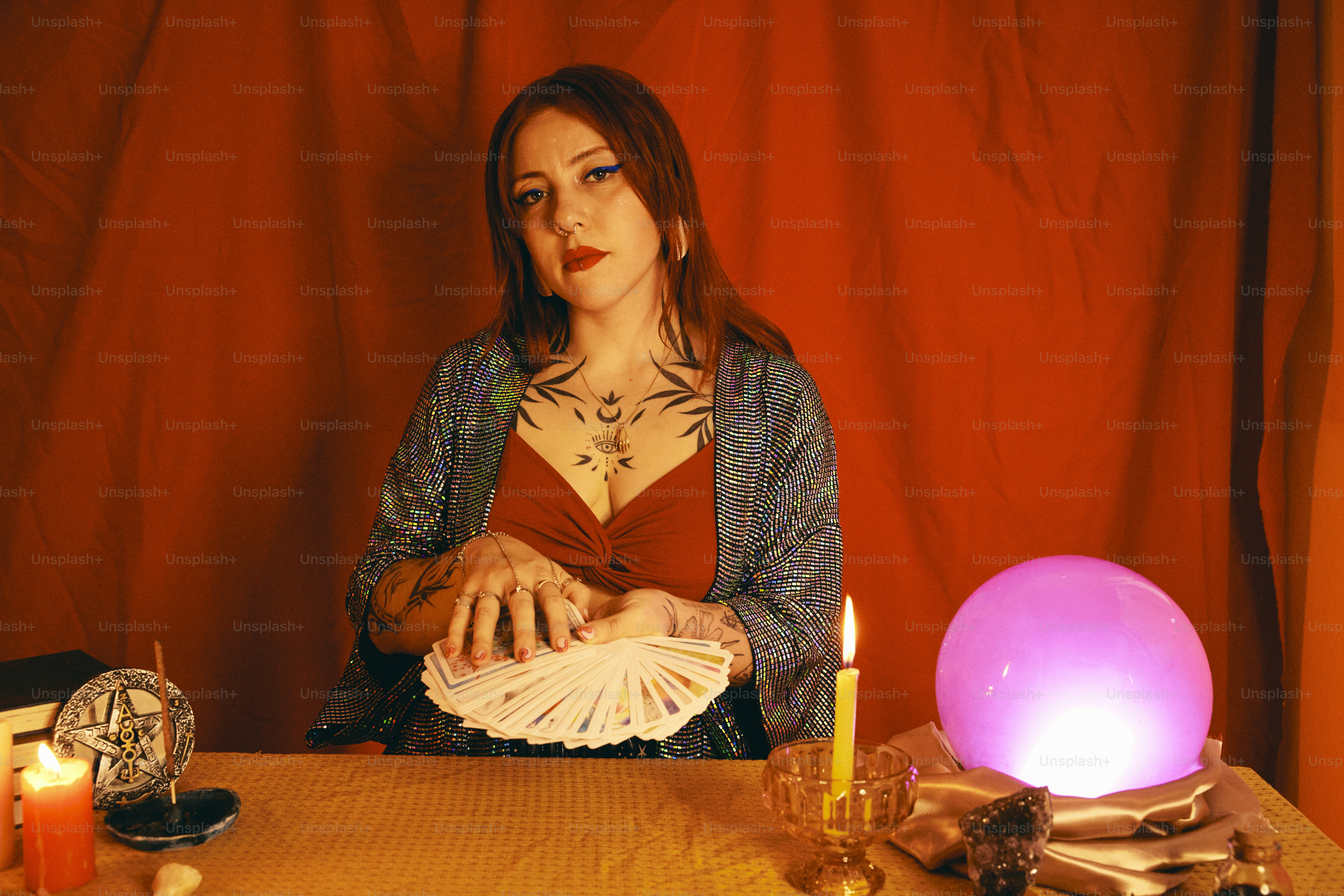 uma mulher sentada em uma mesa com uma vela acesa