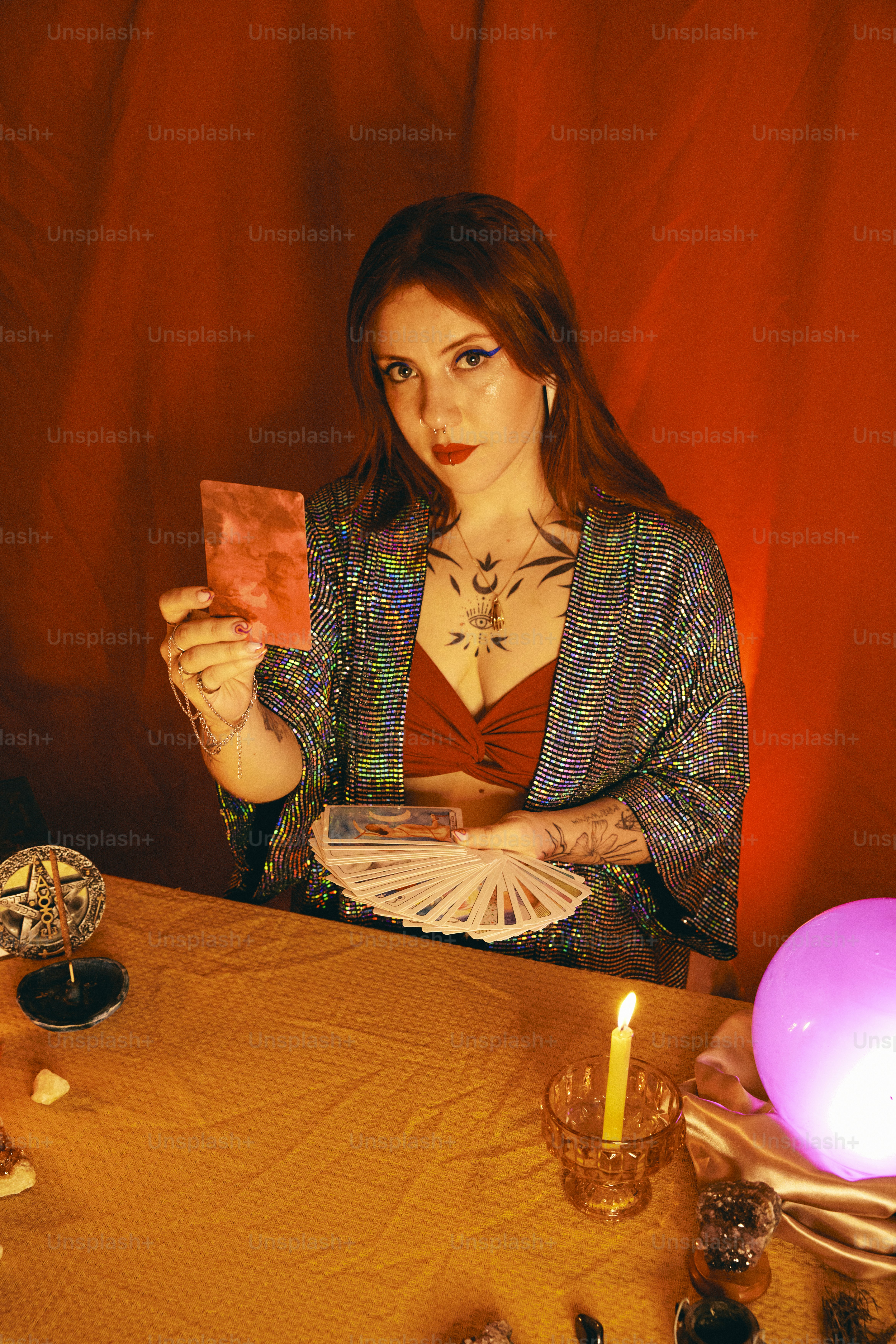 a woman sitting at a table holding a piece of paper