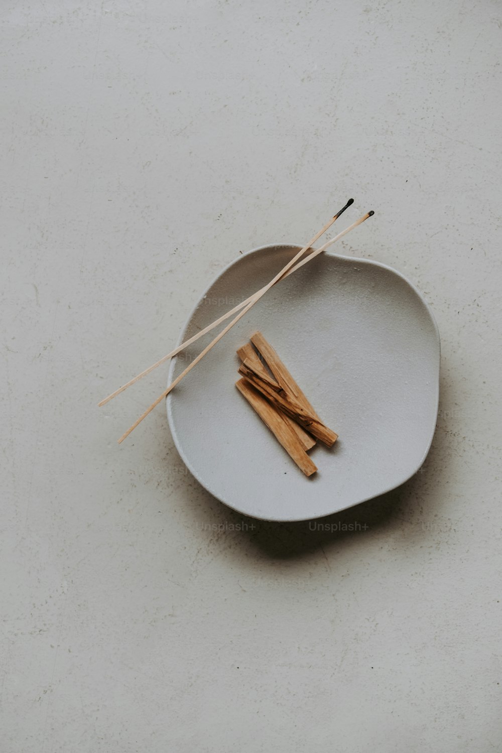 a plate with two sticks on top of it
