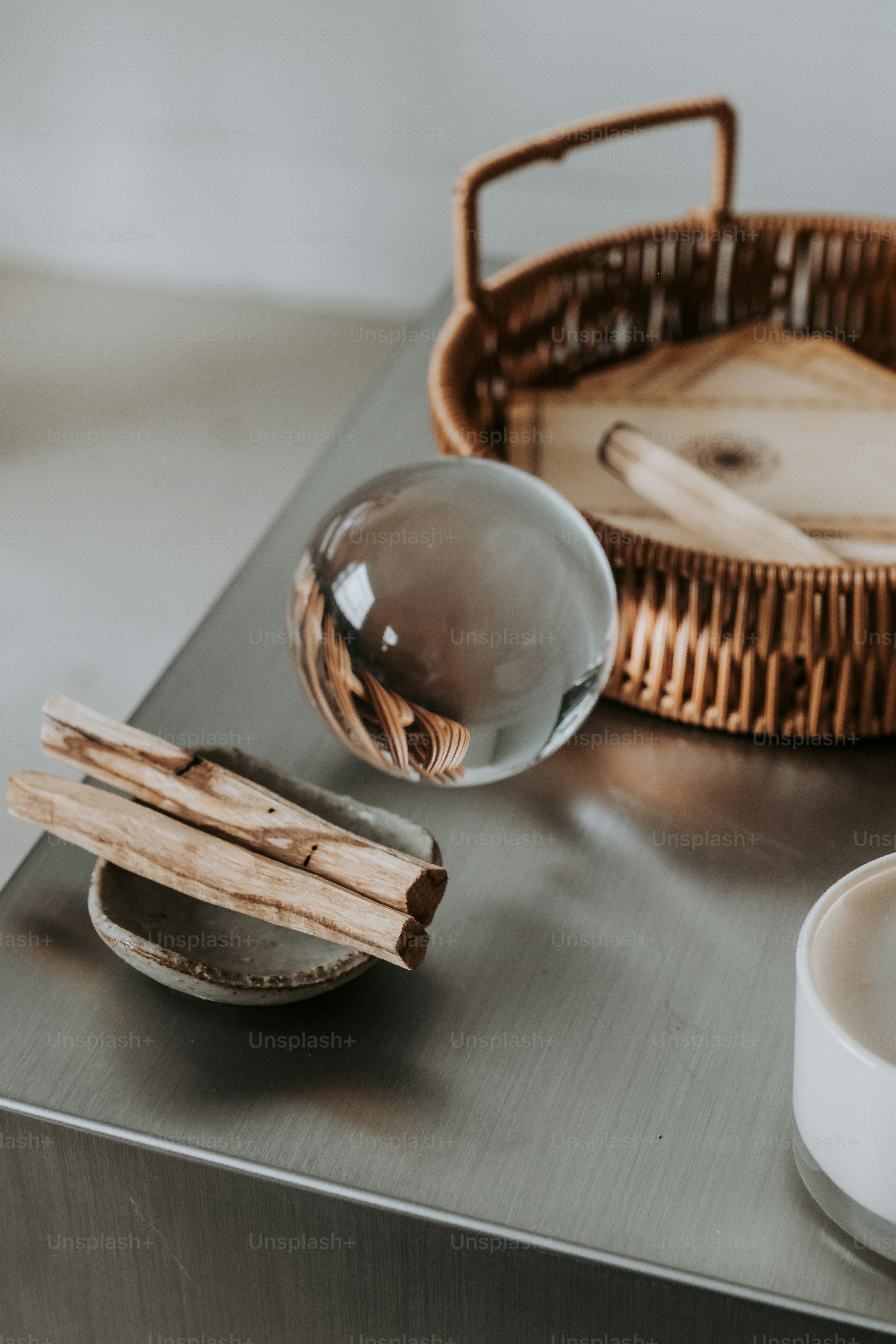 a table with a basket, bowl, spoon and a bowl on it