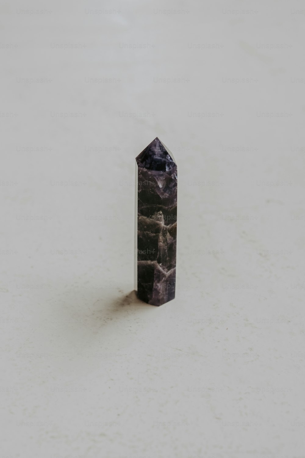 a black object sitting on top of a white floor