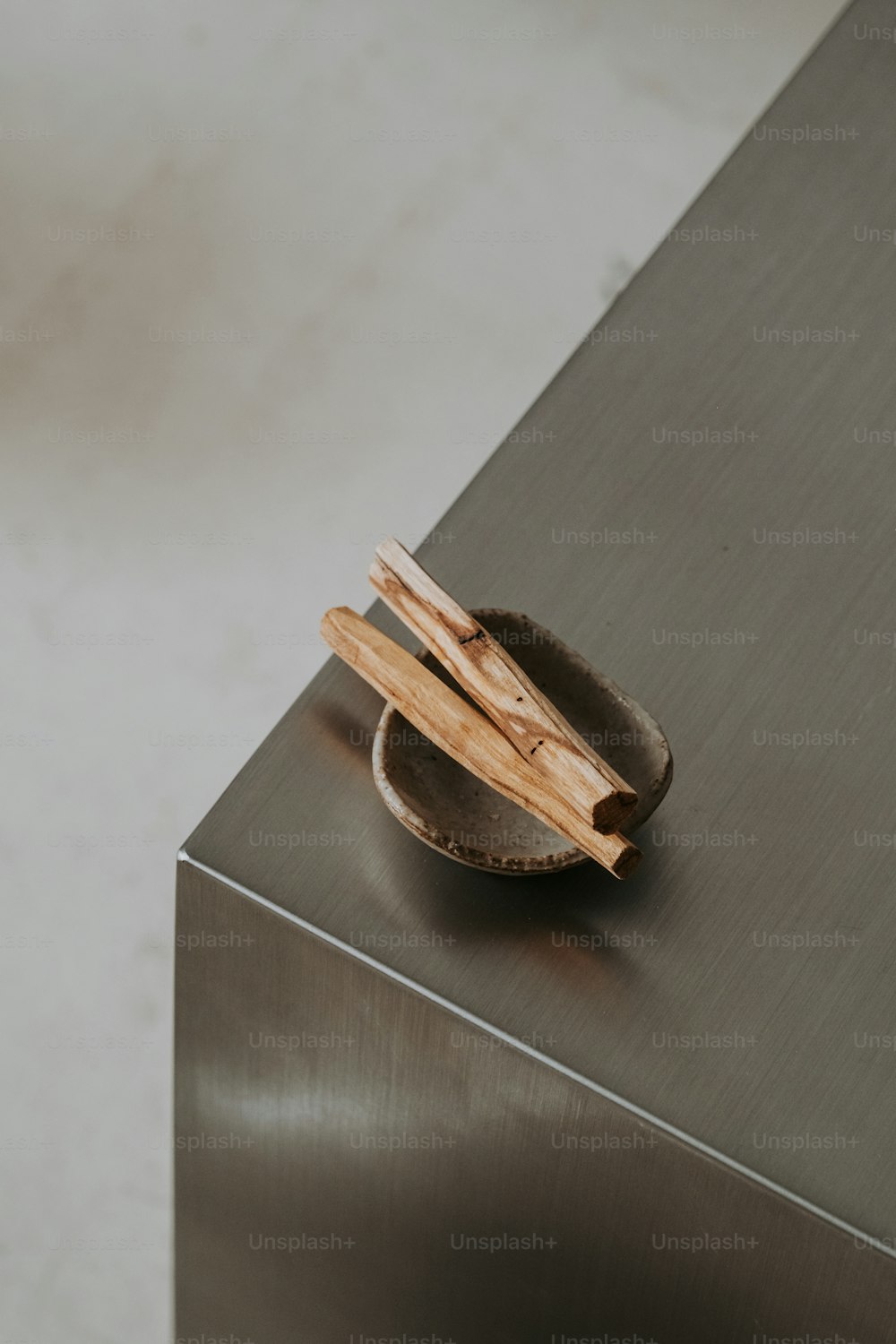 a bowl with chopsticks in it sitting on a table