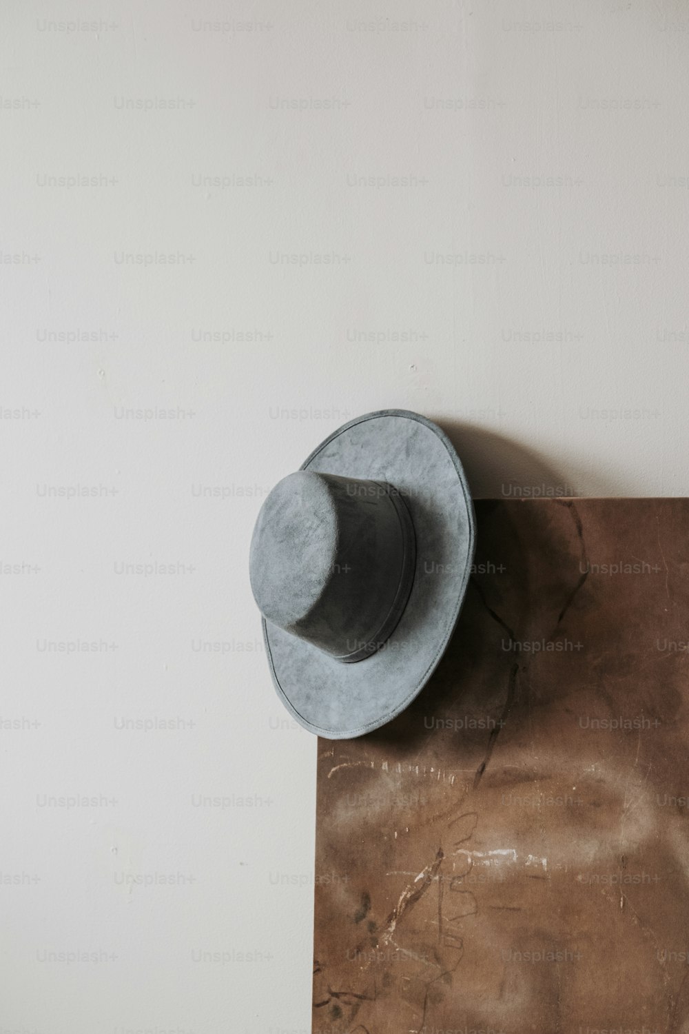 a gray hat sitting on top of a wooden table