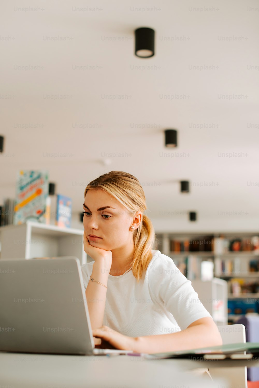 a woman sitting in front of a laptop computer