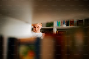 a woman reading a book in a library