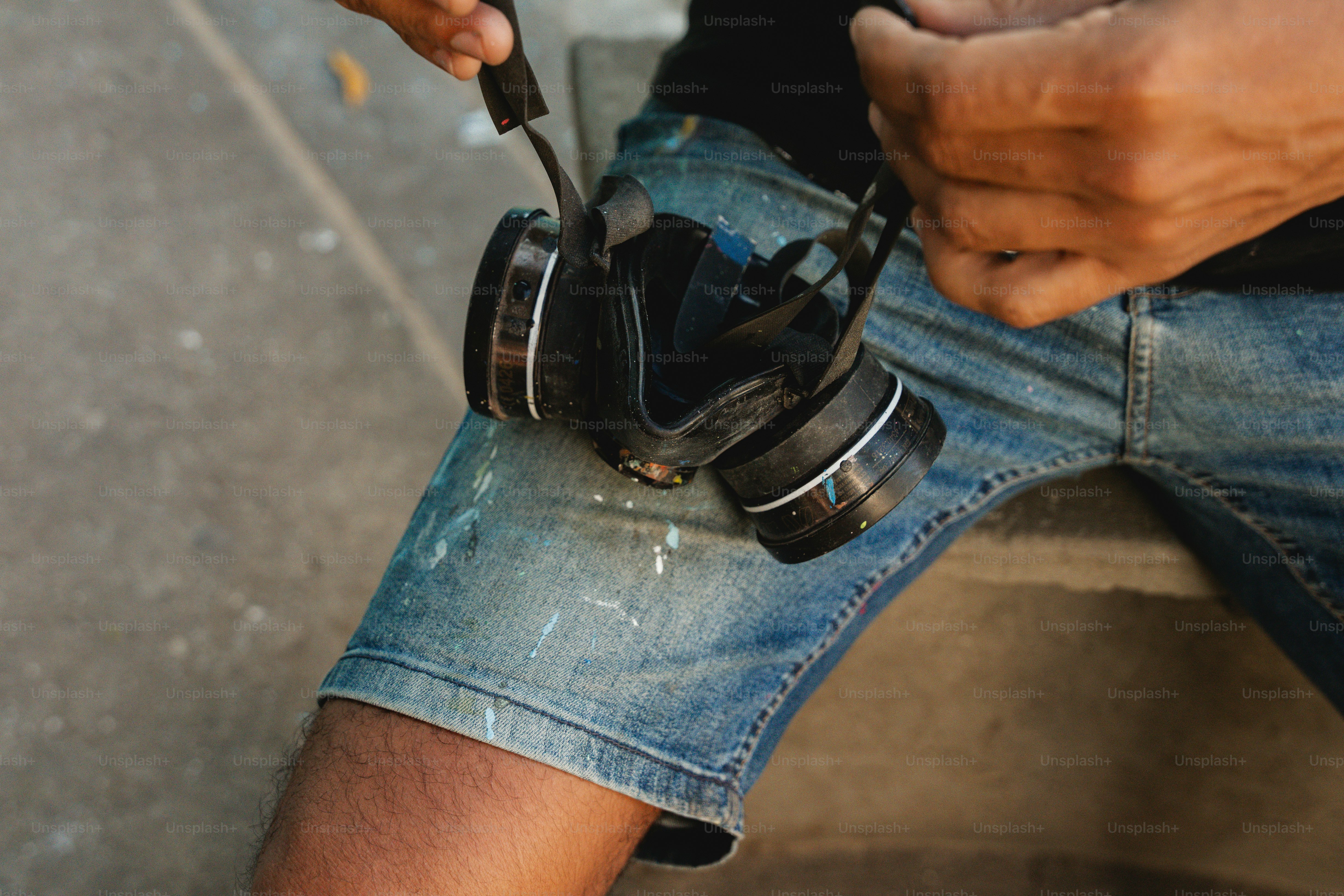 a man sitting on a bench holding a pair of headphones