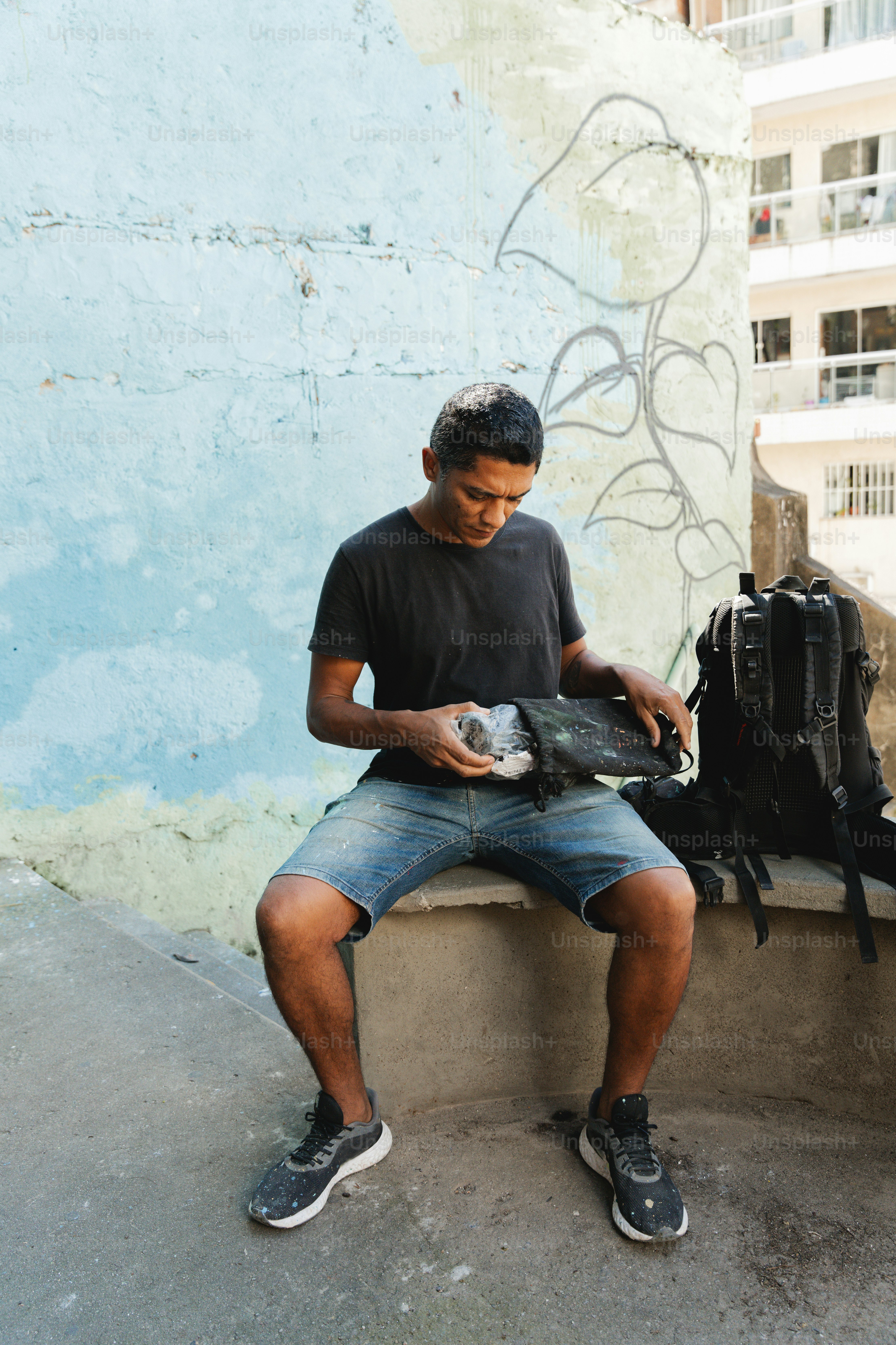a man sitting on a bench looking at a camera
