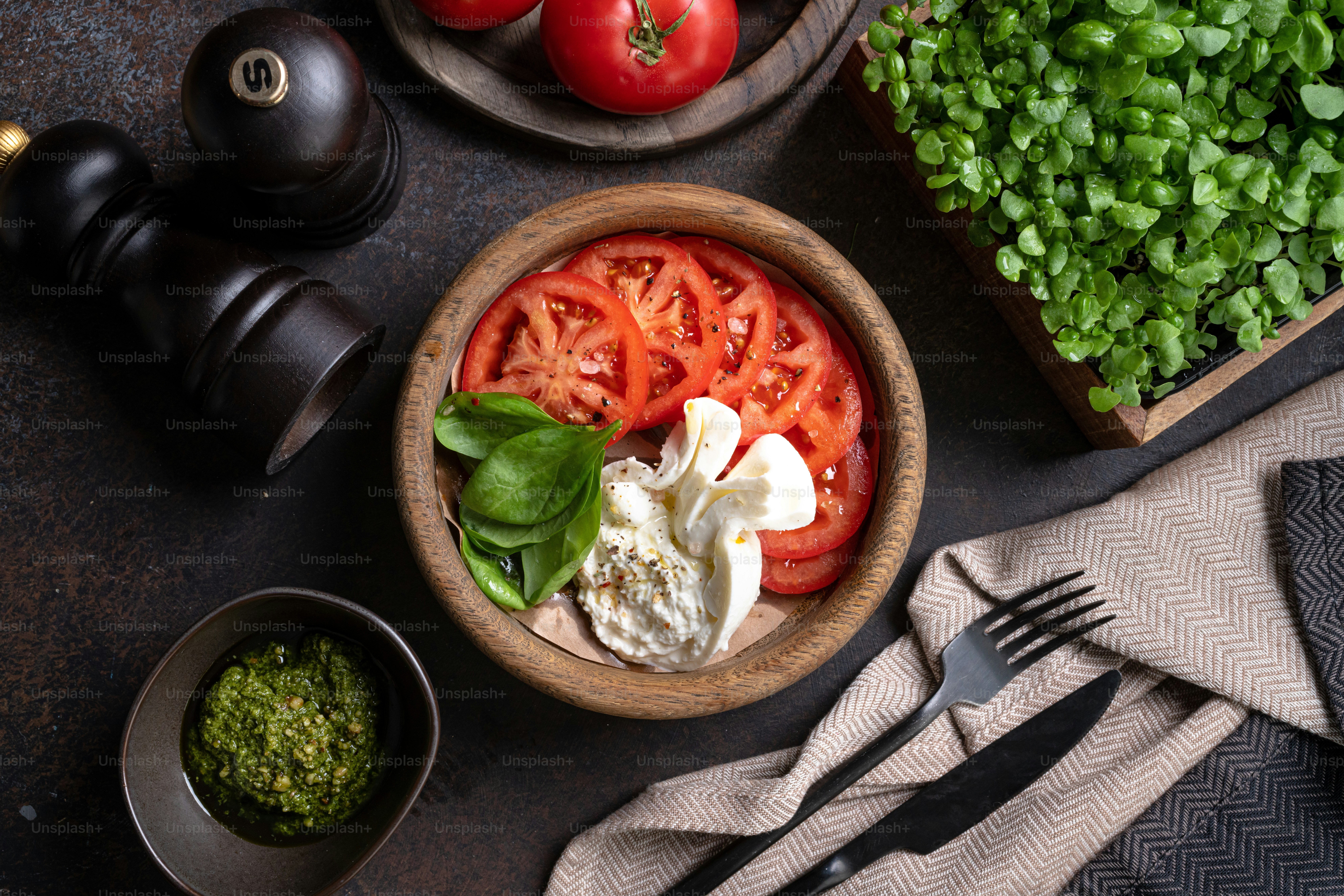 a wooden bowl filled with tomatoes and other vegetables
