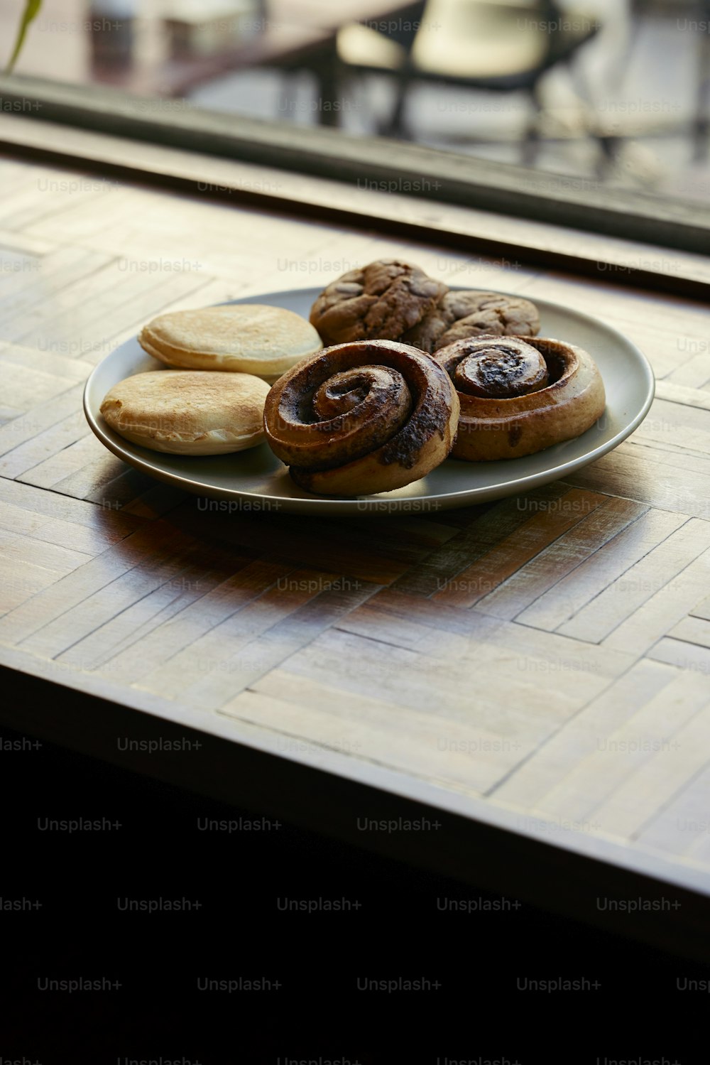 a plate of pastries sitting on a window sill