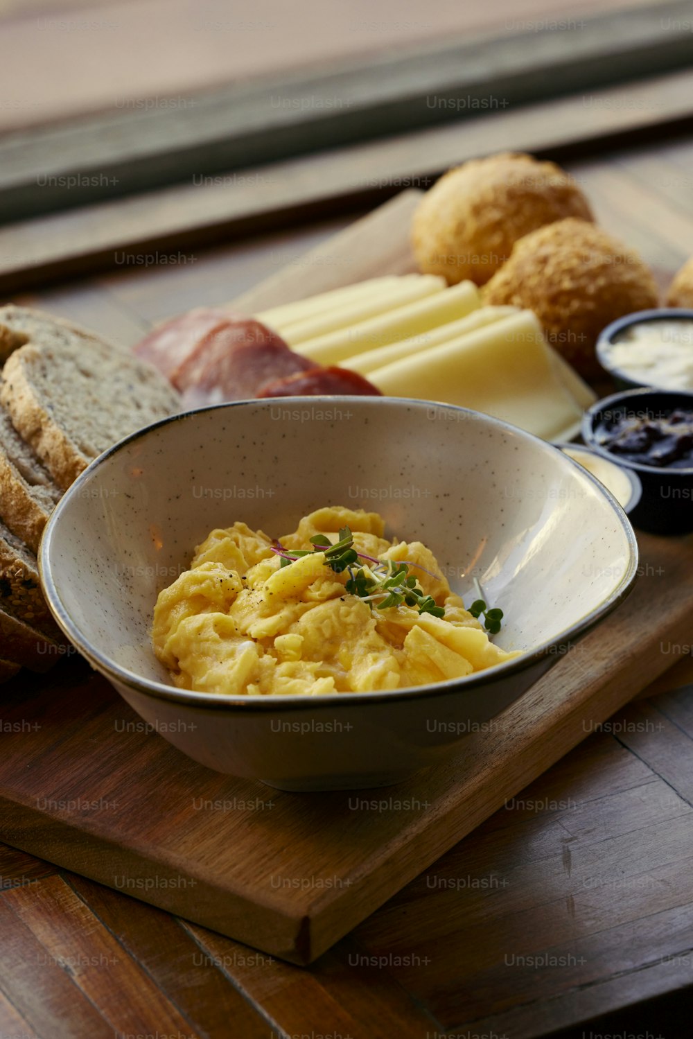 a bowl of scrambled eggs on a cutting board