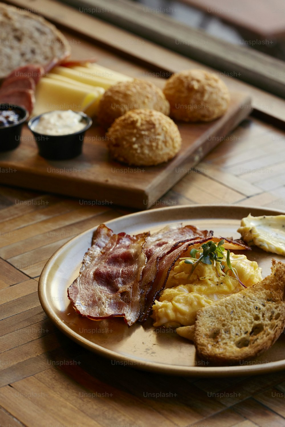 a plate of breakfast food on a wooden table