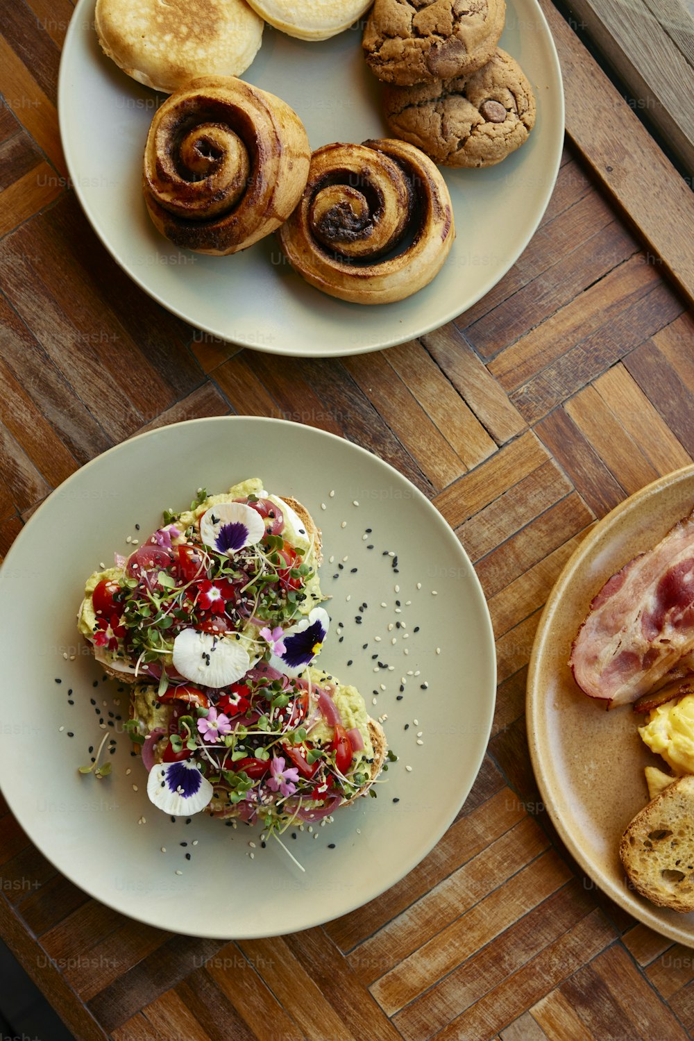 a table topped with plates of food on top of a wooden table